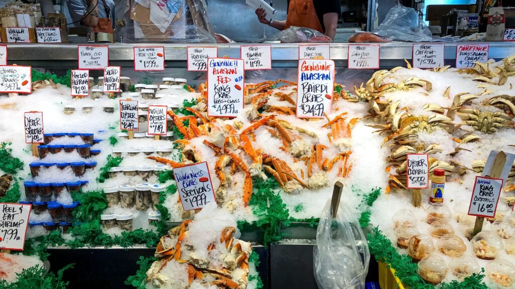 Fishmongers at Pike Place Fish Market tossing fresh seafood