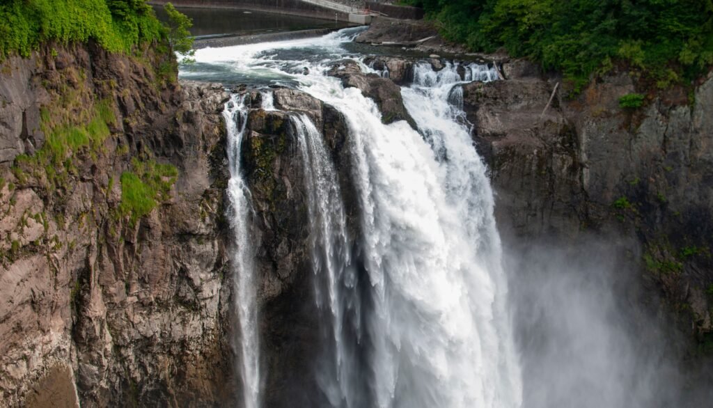 Large waterfall surrounded by evergreen forest